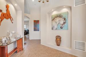 a hallway with art on the walls at Prescott Luxury Home near Golf Course and Airport home in Prescott Valley