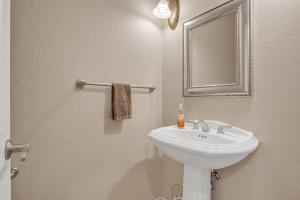 a bathroom with a white sink and a mirror at Prescott Luxury Home near Golf Course and Airport home in Prescott Valley