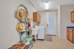 a kitchen with hats on the wall and a sink at Prescott Luxury Home near Golf Course and Airport home in Prescott Valley