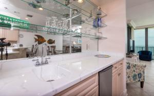 a kitchen with a sink and a large mirror at Phoenix IX 1105 condo in Orange Beach