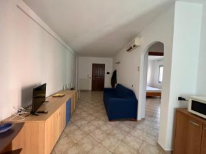 - un salon avec un bureau et une chaise bleue dans l'établissement Appartamento bilocale 4 posti Olbia Codice IUN R3972, à Olbia