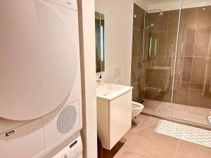 a bathroom with a shower and a sink and a toilet at Penthouse-Nordic-Citycenter-Balcony in Copenhagen +34 photos