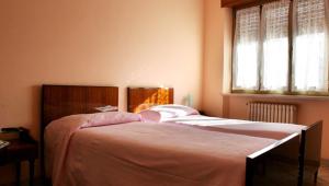 A bed or beds in a room at Albergo Carla