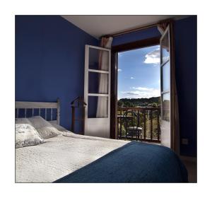 a bedroom with a bed and a sliding glass door at Hotel Rural en Escalante Las Solanas in Escalante