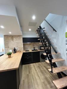 a kitchen with a spiral staircase in a house at Le Darcy, grand appartement centre ville Dijon, proche gare in Dijon