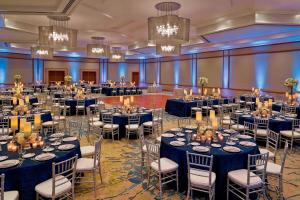 a ballroom with blue tables and chairs and chandeliers at The Westin San Diego Bayview in San Diego