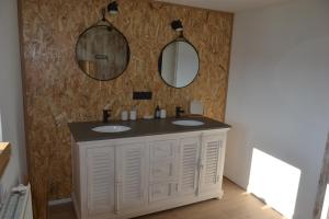 a bathroom with two sinks and two mirrors at La Jo Welcome Home in Theux