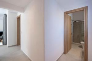an empty room with a door leading to a bathroom at Cycladic Sunlight 2bedroom House in Krotiri +24 photos