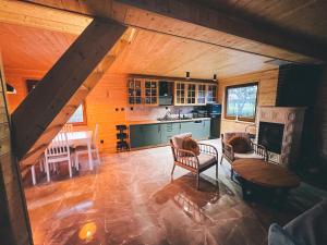 a living room with a kitchen and a table at U Progu Lasu in Budy
