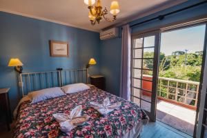 a bedroom with a bed and a large window at Golden Hills Vila Suzana in Canela +54 photos
