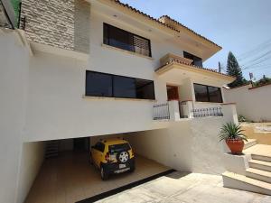 a yellow car parked in front of a house at Casa Ritual in Oaxaca City