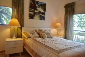 En eller flere senger på et rom på Cadaques Caribe Bayahibe Apartments