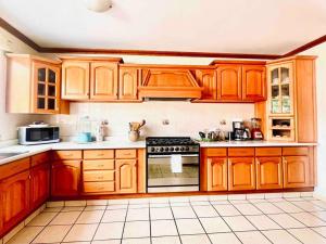 a kitchen with wooden cabinets and a stove top oven at Casa Ritual in Oaxaca City +36 photos