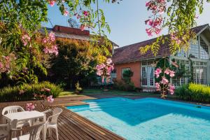 a backyard with a swimming pool and a house at Golden Hills Vila Suzana in Canela