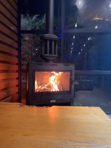 a stove with a fire in a room at Emela Villa in Sapanca