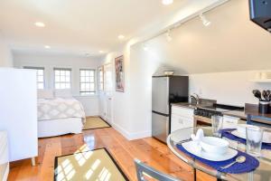 a kitchen and living room with a table and a bed at East End Condo w Beach Access in Provincetown