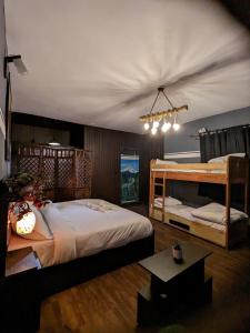 a bedroom with two bunk beds and a table at THE FOX RETREAT in Mukteshwar