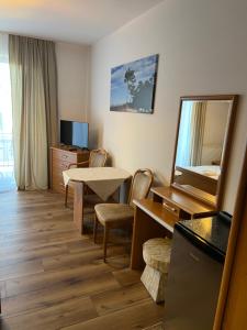 a hotel room with a table and a mirror at Pension Asteria in Krokowa