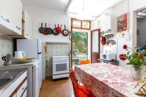 a kitchen with a table and a counter top at Casina Orione in Montecatini Val di Cecina