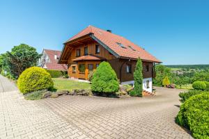 a house with a brick driveway in front of it at Haus Erlenmaier in Schömberg