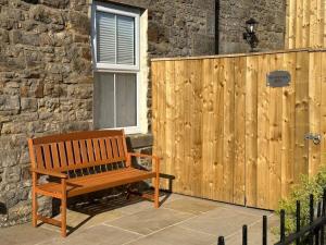a wooden bench sitting next to a wooden fence at Foundry Farm Arch in Bellingham