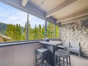 a room with a table and chairs and a large window at CM325 Copper Mtn Inn condo in Copper Mountain