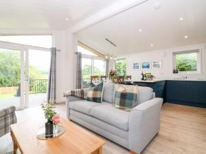 a living room with a couch and a table at Eden Fields Lodge in Cupar