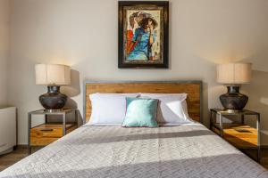 a bedroom with a bed with two night stands at Villa Nirvana in Áyioi Dhéka +48 photos