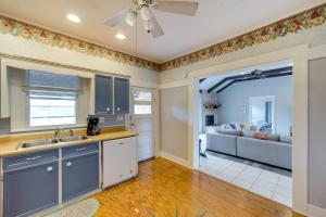 a kitchen with a sink and a living room with a couch at Rural Texas Vacation Rental with Fireplace in Dripping Springs
