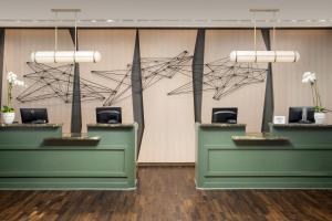 a lobby with two counters with flowers on them at The Westin Dallas Fort Worth Airport in Irving
