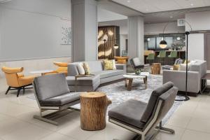 a lobby with couches and chairs and a table at The Westin Dallas Fort Worth Airport in Irving
