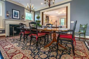 a dining room with a table and chairs on a rug at Stonegate in Lexington