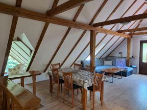 a living room with a table and chairs and a couch at Apartment Iva in Duga Resa