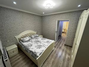 a bedroom with a bed and a hallway with a door at Central Charm Guesthouse in Gyumri