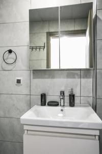 a bathroom with a white sink and a mirror at Just Dream Suites in Kaş