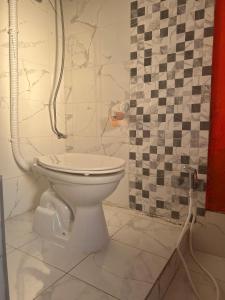 baño con aseo y pared de azulejos en Belgrade Hostel Shambala en Belgrado