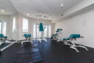 a gym with treadmills and chairs in a room at Destin West Villa Gulfside V406 in Fort Walton Beach