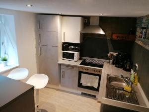 a kitchen with a sink and a stove top oven at Zum Pfarrberg in Meerane