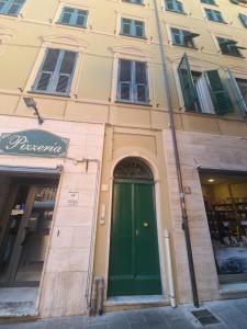 a building with a green door on a street at Rosa Tramonto Portofino by PortofinoVacanze in Rapallo