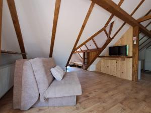 a living room with a couch and a tv at Apartment Iva in Duga Resa