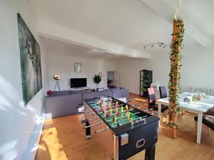 a living room with a table with a foosball at Like King Friedrich - Kicker - Parking - Kitchen in Friedberg