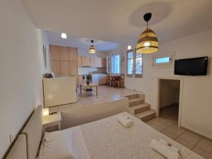 a kitchen and a living room with a dining room at Karaoulanis Apartments in Andros