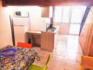 a small kitchen with a sink and a refrigerator at Bed & Breakfast Delle Palme in Trapani