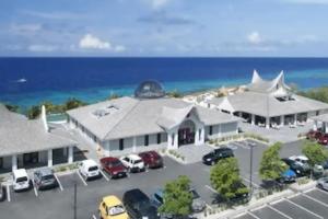 an aerial view of a building with cars parked in a parking lot at Relaxed Studio Near the Beach in Jan Thiel