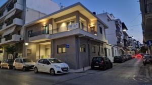 a building with cars parked on the side of a street at Magdalena Suite 2.0 in Heraklio