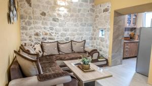 a living room with a couch and a table at Authentic Vacation Flat Near Beach in Kotor in Kotor