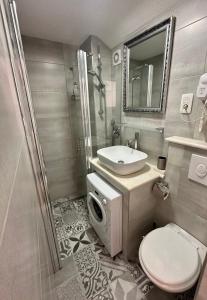 a bathroom with a toilet and a sink and a shower at Fabo Aparments in Split