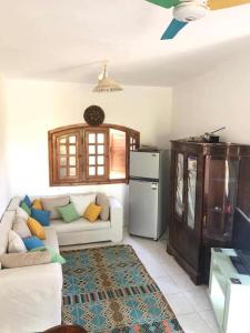 a living room with a white couch and a refrigerator at Beit Rumi in El Alamein