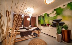 a bedroom with two beds and a window and plants at Sunset Spa in Rewal