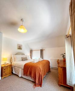a bedroom with a large bed and a window at The Old Chapel in Axminster